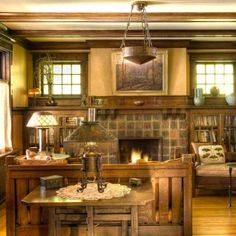 a living room filled with furniture and a fire place in the middle of a room