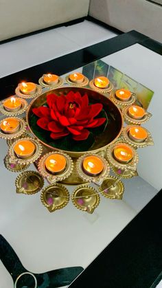 a table topped with candles and a red rose