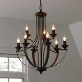 a chandelier hanging from the ceiling in a room with white walls and windows