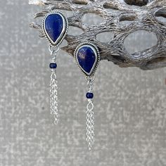 Genuine Lapis Lazuli and Sterling Silver Stud Earrings These earrings are made with sterling silver, designed and created by me in my Arizona studio.  The deep blue in these Lapis stones is the most sought after color of Lapis and has sparkling flecks of Pyrite. The teardrop studs are accented with a small Lapis bead and sterling silver chain fringe, making them a fun alternative to basic studs.   The setting of the stones are 5/8 X 7/8 with the total length of the earrings being 2 1/2 inches. Bohemian Sterling Silver Gemstone Earrings, Spiritual Sterling Silver Teardrop Earrings, Spiritual Teardrop Sterling Silver Earrings, Silver Lapis Lazuli Pierced Earrings, Artisan Sterling Silver Earrings With Natural Stones, Bohemian Lapis Lazuli Earrings, Silver Lapis Lazuli Gemstone Earrings, Silver Lapis Lazuli Dangle Earrings, Silver Lapis Lazuli Drop Earrings