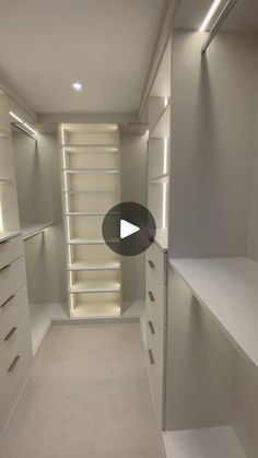 an empty walk in closet with shelves and lights on the ceiling is being viewed by a video player