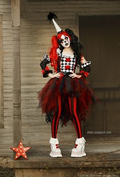 a woman dressed as a clown posing for the camera