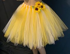 "This Beautiful sunflower tutu is Multi-Layered. Comes in two length, above the knees and knee length. This Blooming Sunflower tutu is made from Rich Vibrant Yellow and Deep Bold white tulle material. The sewed on Sunflowers attached to the waistline is a nice accent to enhances the overall theme of the skirt. Handmade from 100% Polyester(Tulle). Soft, Comfortable 1 inch Elastic Waistband. Lightweight and fun to wear. The same length are Available in your favorite colors as well , please leave t Yellow Tutu Dress With Tulle Skirt For Spring, Spring Yellow Tutu Dress With Tulle Skirt, Yellow Tulle Tutu Dress For Spring, Spring Yellow Tulle Tutu Dress, Fitted Yellow Tutu Dress With Tulle Skirt, Yellow Tutu Skirt, Sunflower Tutu, Plus Size Tutu, Bumble Bee Costume