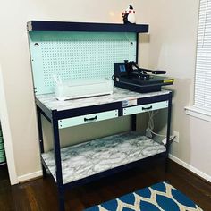 a sewing machine sitting on top of a table next to a blue and white rug