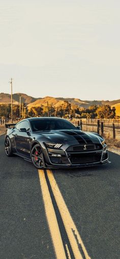 a black sports car driving down the road