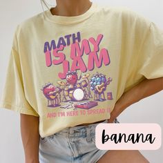 Math Is My Jam - Comfort Colors 1717 Tee Description: Celebrate your love for numbers and equations with our "Math Is My Jam" t-shirt! Perfect for math teachers, students, or anyone who adores the beauty of mathematics, this tee is a stylish and comfortable way to show off your passion for the subject that makes the world go round. Key Features: Premium Quality: Crafted from 100% ring-spun cotton, the Comfort Colors 1717 tee is known for its soft, durable fabric that only gets softer with each w Bookish Jewelry, English Teacher Shirt, Volleyball Shirts, Pom Pom Girl, Lovers Romance, My Jam, Comfort Colors Shirt, Special Education Teacher, Color Care