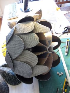 a bunch of hats sitting on top of a wooden table next to a computer keyboard