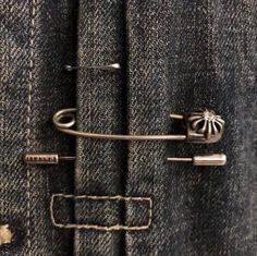 a pair of scissors is stuck in the pocket of a jean jacket