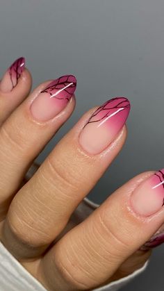 a woman's hand with pink and black nail polish