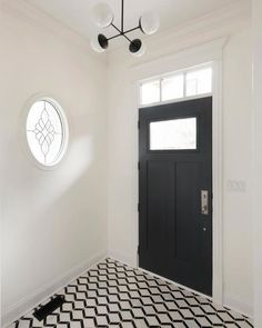 a black and white checkered floor in front of a door with a round window