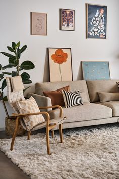 a living room filled with furniture and pictures on the wall above it's couch