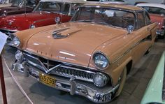 an old car is on display in a museum