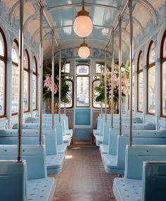 the inside of a train car with blue seats and flowers on each seat, in front of two windows