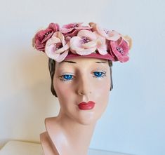 This is a lovely hat from the late 1950's. Made in a muted pink velvet with a shallow crown and a softly curving brim. Trimmed with velvet petaled flowers around the front and sides in a palette of the same pink velvet and light pink velvet flowers with stand up pistils at their centers. Small velvet bow at the back. Interior hat is lined in pink faille and has grosgrain ribbon trim around the inside crown. Velvet encased head wires hold the hat in place. Label:  None.  Professional construction Condition:  Excellent.  Lightly used only.  Some light bending of the hat on the top only.   Size/Measurements:  Fits all head sizes height-  2.25" diameter-  8" Vintage Fitted Pink Headpiece, Vintage Pink Fitted Headpieces, Fitted Vintage Pink Headpiece, Pink Vintage Fitted Headpiece, Vintage Pink Fitted Fascinator, Vintage Pink Adjustable Mini Hats, Vintage Pink Hat For Royal Ascot, Vintage Pink Hat For Evening, Vintage Pink Mini Hat With Curved Brim