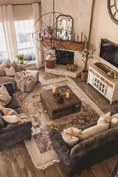 a living room filled with furniture and a flat screen tv mounted to the wall next to a fire place