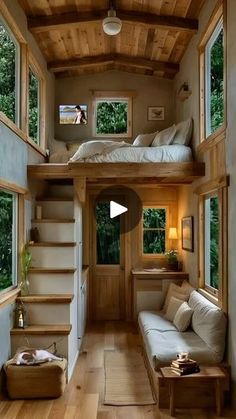 the interior of a tiny house with stairs leading up to the bedroom and living room