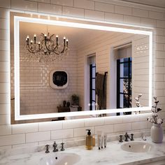 a bathroom with two sinks and a large mirror on the wall above it that is illuminated