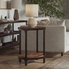 a living room filled with furniture and a lamp on top of a wooden table next to a couch