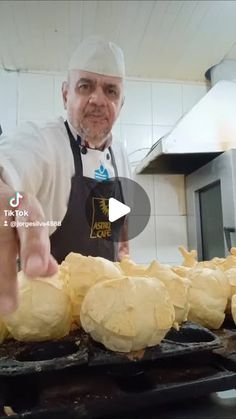 a man in an apron is cooking some food