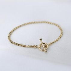 "14K GoldToggle Rolo Chain Bracelet - 14K Gold 2mm Rolo Chain Bracelet ★ 14K gold 2mm rolo chain ★ 14K gold toggle clasp ★ All components are 14K solid yellow gold The length includes the chain and the closure. Please measure your wrist before you place your order. ** How to choose a correct size of bracelet. 1. Measure your wrist below the wrist bone using a flexible tape measures, a string or a strip of paper. 2. If using a string or a strip of paper, mark length. Then, measure it with a ruler Yellow Gold Plated Bracelet With Toggle Clasp, Yellow Gold-plated Bracelet With Toggle Clasp, Timeless 14k Gold Chain Bracelet With Spring Ring Clasp, Yellow Gold Plated Chain Bracelet With Spring Ring Clasp, Gold Chain Bracelet For Everyday, Timeless Link Gold Bracelet, Gold Plated Yellow Gold Chain Bracelet, Classic Gold Bracelet With Toggle Clasp, Everyday Yellow Gold Chain Bracelet With Toggle Clasp