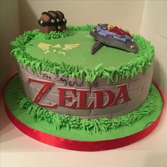 a birthday cake with the legend of zelda on it's top and green frosting