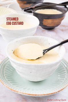 two bowls filled with batter and spoons on top of a table