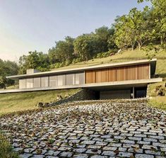 the house is surrounded by grass and rocks