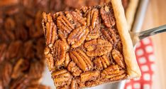 a piece of pecan pie being held by a fork