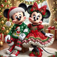 two mickey and minnie mouses dressed up for christmas