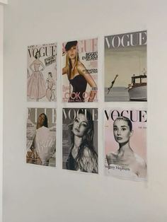 four magazine covers are hanging on the wall