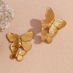 These Large Gold Butterfly Earrings make a bold statement with their stunning design. Perfect for adding a touch of elegance and sophistication to any outfit. These earrings will surely catch attention and elevate any look. DETAILS & SIZE Sold as a pair Finish: 18K gold plate Material: Stainless Steel Measurements: 1.6"x1.2" Weight: 12.6 grams Comes with friction earring backs Waterproof, tarnish-resistant, and nickel free Shop Earrings to curate your ear stack! Gold Butterfly Earrings For Wedding, Gold Butterfly Earrings For Formal Occasions, Gold Butterfly Earrings For Party, Elegant Gold Butterfly Earrings, Luxury Gold Butterfly Earrings, Luxury Yellow Gold Butterfly Earrings, Gold Butterfly Metal Earrings, Gold Plated Butterfly Earrings, Gold-plated Butterfly Earrings