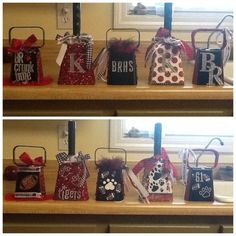 several bags with different designs on them are sitting on a shelf in front of a window