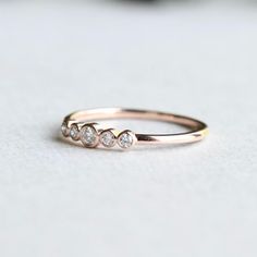 three diamond ring sitting on top of a table