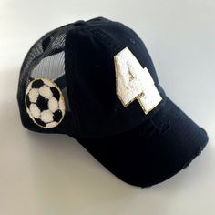 This custom Soccer mom hat is perfect for any game! Put your Childs number on the hat with a soccer ball on the side! Hats come in a variety of colors and the number patches come in red, black, or white with a glittered gold background. If you do not see the color hat you are looking for just contact me! Numbers are approximately 3 inches long and made out of Chenille. First picture is show in black. Other sports options in my shop are Baseball Softball Football Basketball Volleyball Hockey LaCr Soccer Number, Soccer Mom Gifts, Mom Hat, Mom Hats, Patch Hat, Basketball Mom, Football And Basketball, Gold Background, Soccer Mom