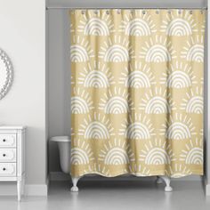 a bathroom with a yellow shower curtain and white cabinet next to the bathtub in front of it