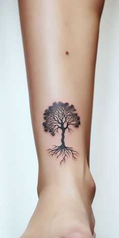 A captivating minimalistic tree ankle tattoo, subtly symbolizing resilience and the beauty of nature. Botanical Tattoos, Aesthetic Tree, Tattoo Style Art, Majestic Tree, Buddha Tattoo Design, Inner Forearm Tattoo