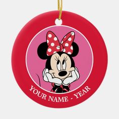 a red ornament with a minnie mouse on it's face and the words your name - year