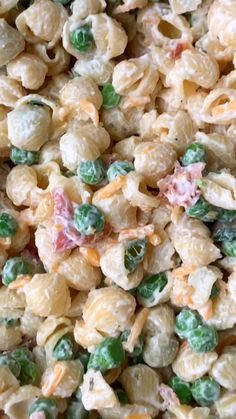 macaroni and cheese with peas is shown in close - up view from above