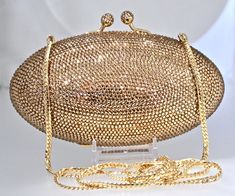 "Heart- stoppingly beautiful design and sparkle! These Evening Formal Oval shaped Purses in gold, gold with pearls and ALL CLEAR will be the talk of town!! Each is handmade. Each takes months to complete, one crystals at a time! Here at Etsy, we offer you the best quality at discounted prices, a fraction of what high priced retailers charge! These are evening bags that are fully covered in genuine, very fine, small sized Swarovski Crystals from Austria! One purse is in all CLEAR CRYSTALS, One is Luxury Formal Clutch With Bling, Luxury Bling Clutch For Formal Events, Luxury Bling Clutch For Formal Occasions, Gold Sparkling Evening Bag For Formal Occasions, Luxury Sparkling Clutch For Weddings, Luxury Sparkling Evening Bag For Events, Luxury Jewelry For Events, Elegant Bedazzled Formal Jewelry, Glamorous Gold Jewelry For Events