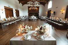 the tables are set up with candles and flowers for an elegant wedding reception or special event