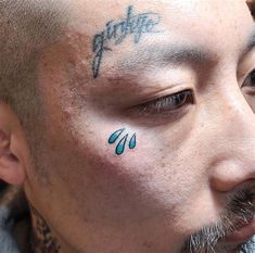 a man with tattoos on his face and nose