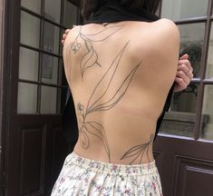 the back of a woman's body with flowers on it