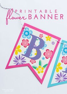 the printable flower banner is hanging from a string