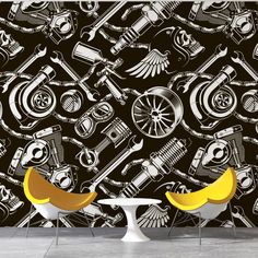 two chairs sitting next to each other in front of a wall with motorcycles on it