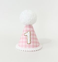 Our baby pink gingham party hat is made of gingham fabric and high quality felt. White big wool Pom is handmade. Comes with pompom trim and elastic band attached to it. Size is H 12 cm W 8 cm Please  make sure the size meets your expectations before ordering IMPORTANT: Please do not give it to the baby or kids to play with. It can cause choking due to small particles or decorations. So please take that granted. THANK YOU Kindly note: Make sure your address is correct during checkout to avoid pro Cute Pink Mini Hats For Birthday, Playful Pink Mini Hats For Birthday, Playful Pink Mini Hats For Birthdays, Cute Pink Mini Hat For First Birthday, Pink Mini Hats For Summer Birthday, Pink Gingham Party, Gingham Party, Daisy Birthday, Big Wool