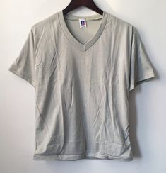 "90s russell athletic S/S V-neck tee. deadstock. NWOT. light grey. 50/50 blend. 26\" long. 19\" across. 9\" arms. in excellent, unworn condition. multiple sizes, colors & quantities available. made in USA. russell athletic founded in 1902. for the long run. legit. legitvintage.etsy.com legitvintage on instagram" Gray Relaxed Fit V-neck T-shirt, Comfortable Gray V-neck T-shirt, Relaxed Fit Sports T-shirt V-neck, Relaxed Fit V-neck T-shirt For Sports, Relaxed Fit V-neck Sports T-shirt, Vintage Russell Athletic, Navy Blue Shirts, Long Run, Russell Athletic