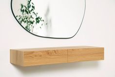 a wooden shelf with a mirror on the wall