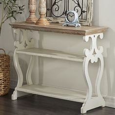 a white shelf with a clock on it next to a plant in a vase and a mirror