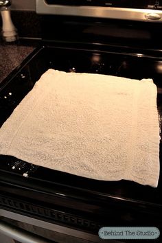 a white towel sitting on top of an oven