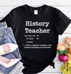 The perfect gift for your favorite history teacher. Teacher Appreciation Week is in May! The UNISEX soft-style t-shirt puts a new spin on casual comfort. Made from very soft materials, this tee is 100% cotton for solid colors. Heather colors and sports grey include polyester. The shoulders have twill tape for improved durability. There are no side seams. The collar is made with ribbed knitting to prevent curling damage.  .: 100% ring-spun cotton (fiber content may vary for different colors) .: L Back To School Teacher Appreciation T-shirt, Back To School Letter Print Crew Neck T-shirt, Cotton T-shirt With Name Print For Teaching, Black Text Print Top For Back To School, Casual Tops With Text Print For Teaching, Relaxed Fit Short Sleeve T-shirt For Teaching, Back To School Graphic Print T-shirt Gift, Back To School T-shirt With Text Print For Teaching, Back To School Graphic Print T-shirt As Gift